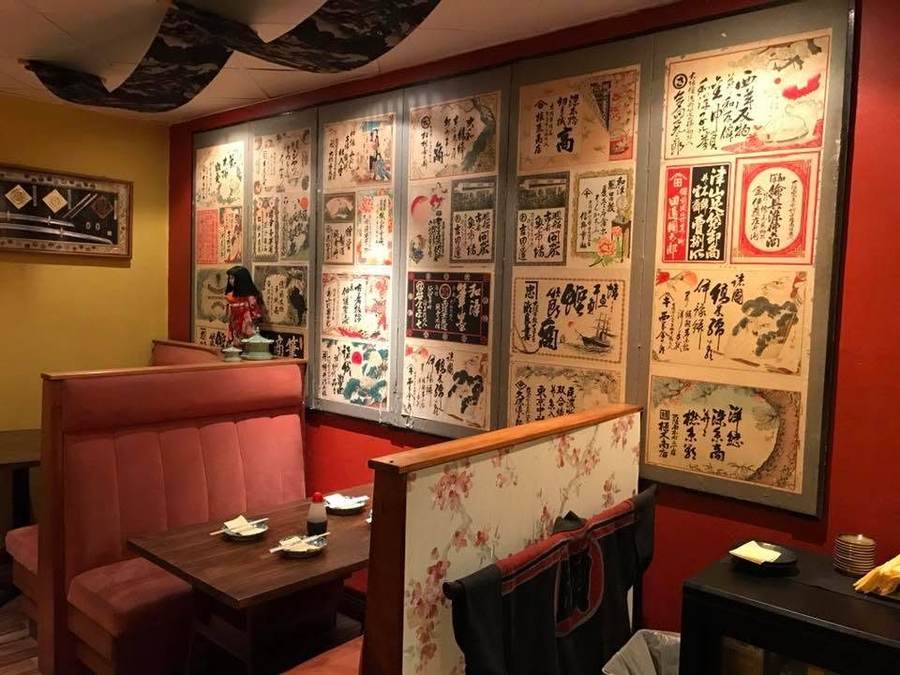 Booth seating against the red wall